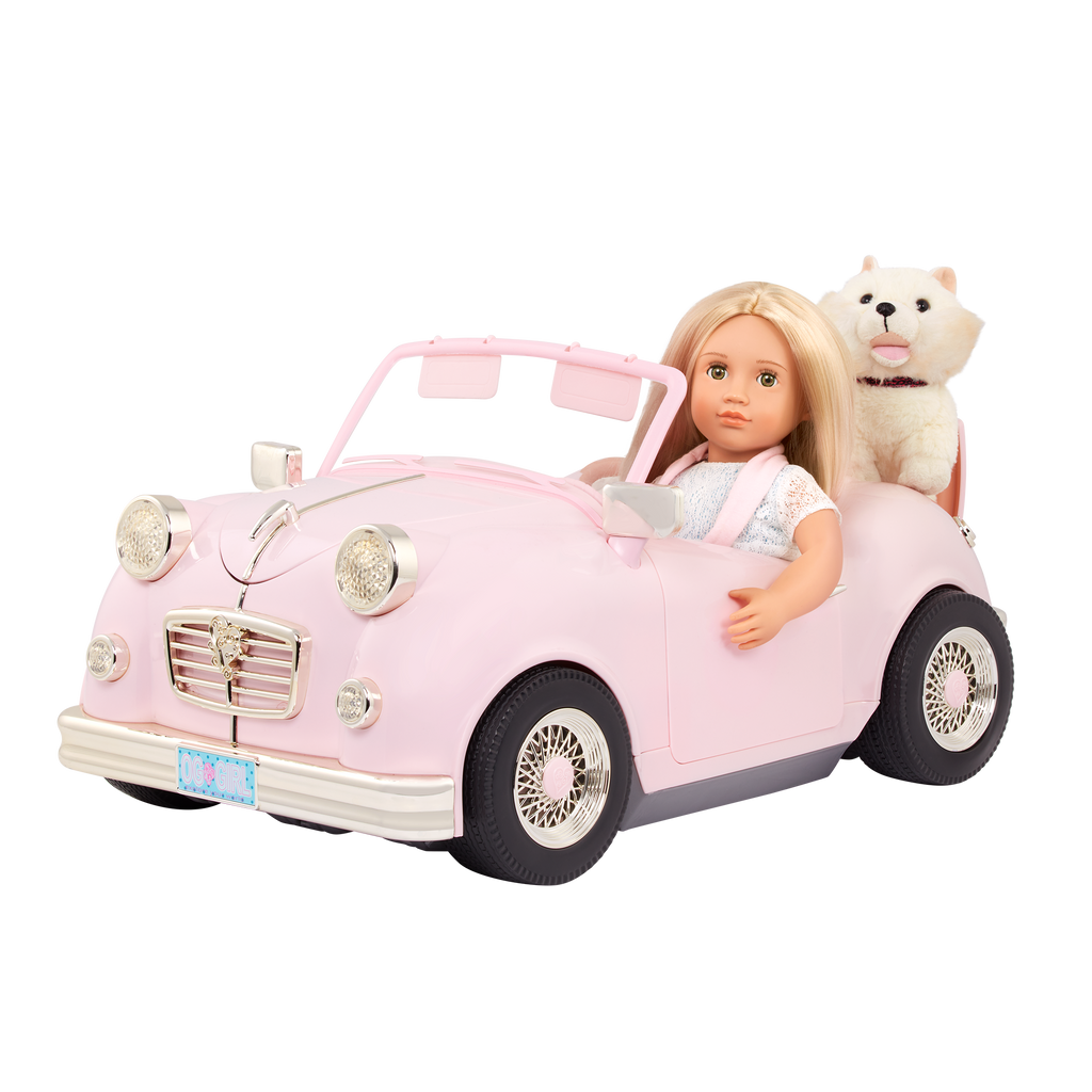 A pink and gold toy convertible car with a 18-inch doll and a stuffed animal inside, designed for play.