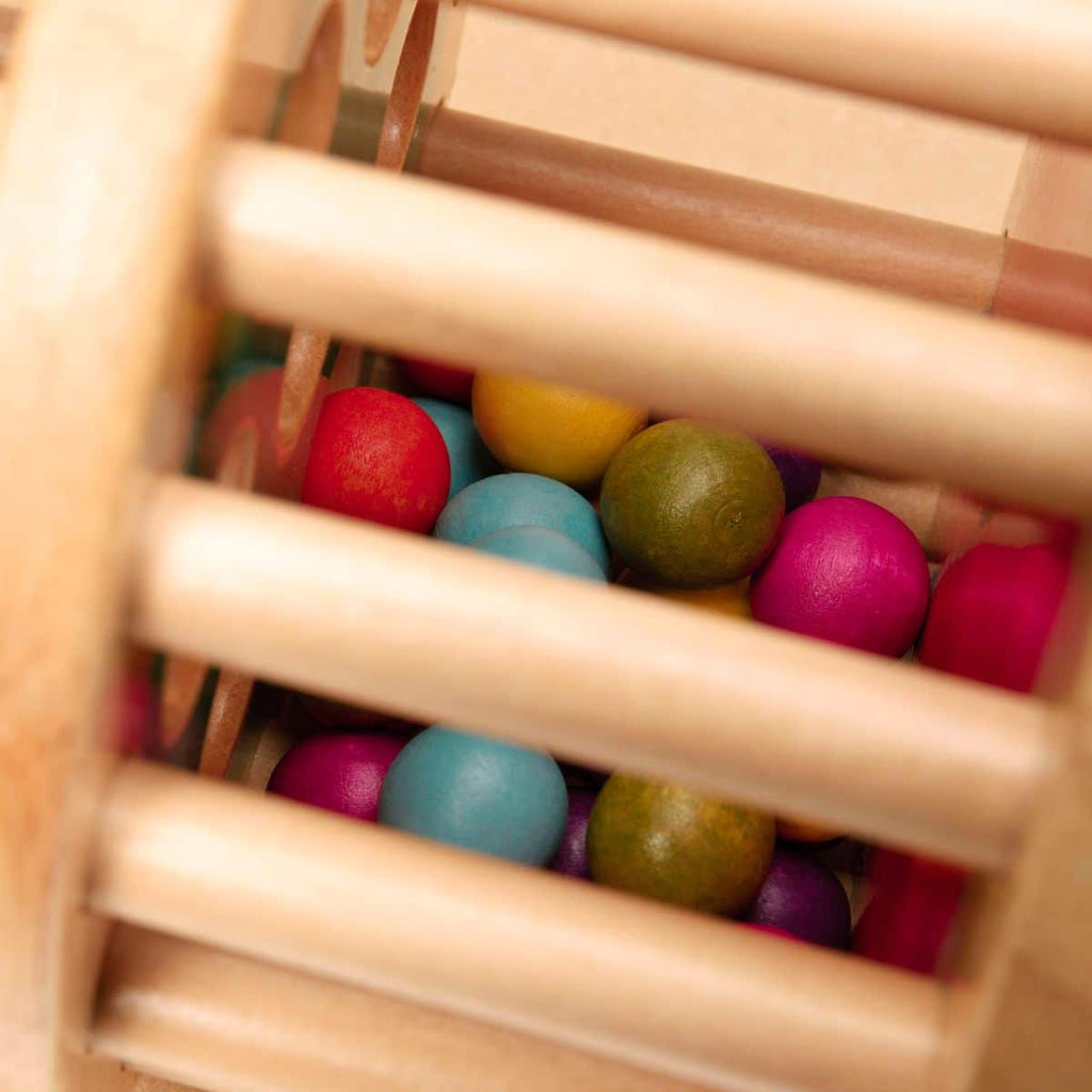 Rolling tower filled with colorful wooden marbles