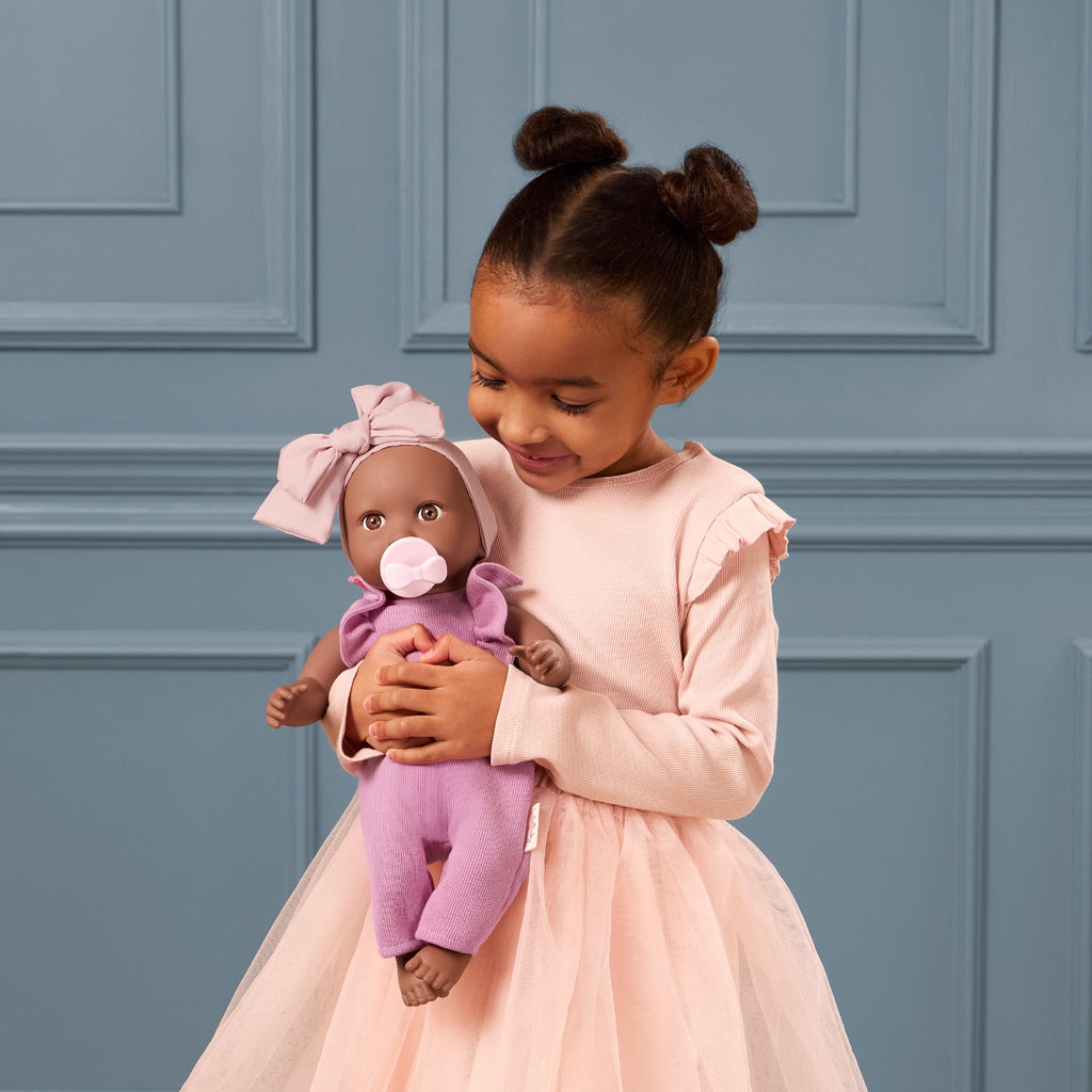 LullaBaby doll in purple romper